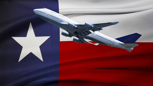 An airplane taking of with the Texas flag in the background.