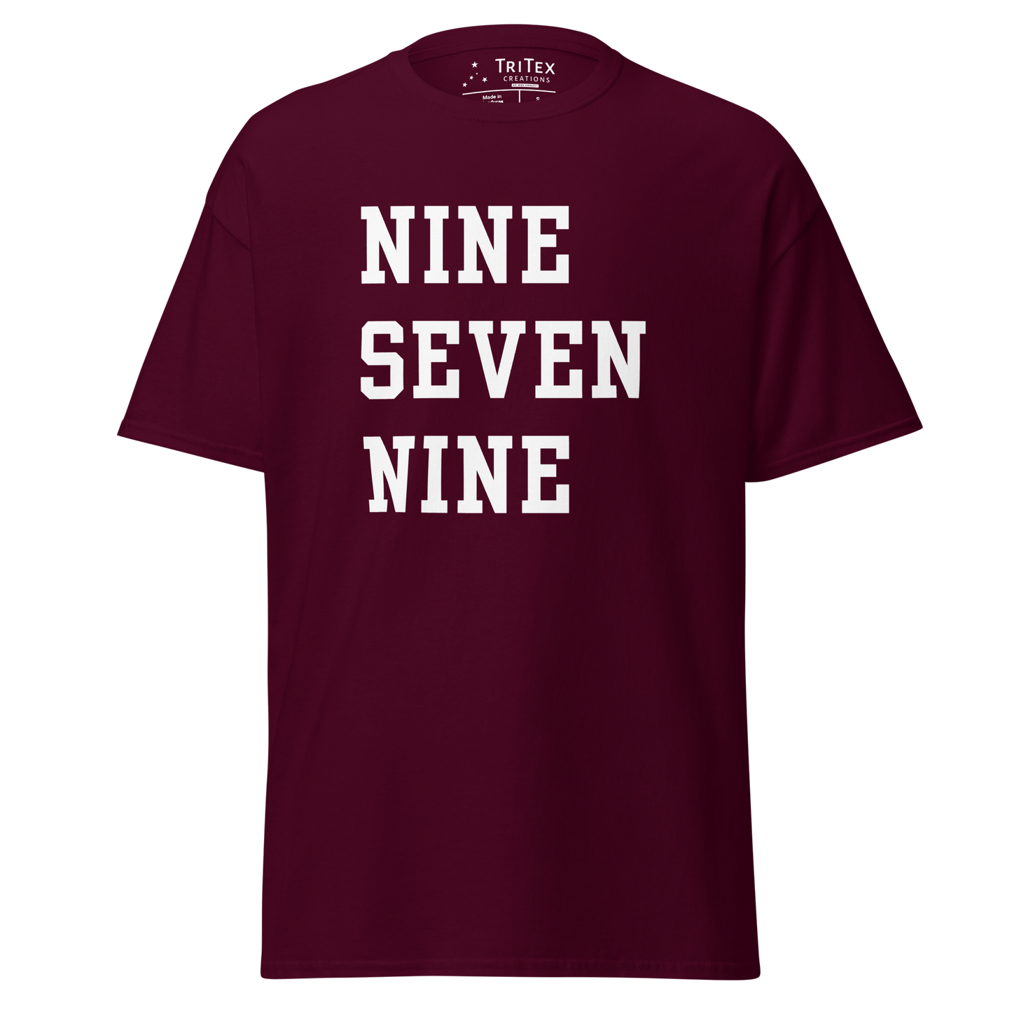 A maroon t-shirt with the words "NINE SEVEN NINE".