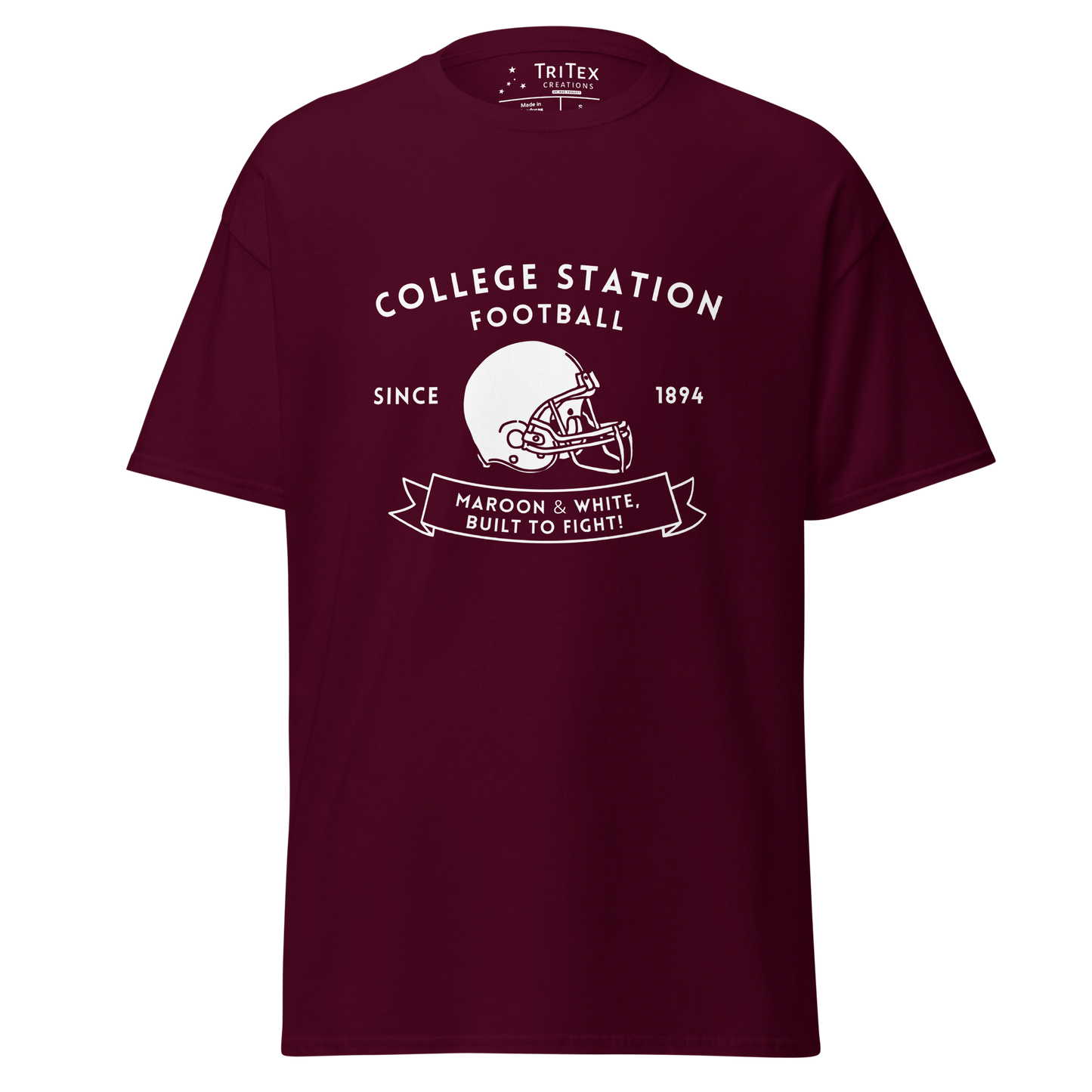 A maroon t-shirt with the text "College Station football since 1894 Maroon & White, Built to fight!" featuring an image of a football helmet.