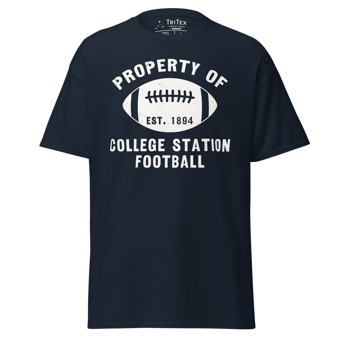 A navy blue t-shirt featuring a silhouette of a football with the words "Property of College Station football. Est. 1894".