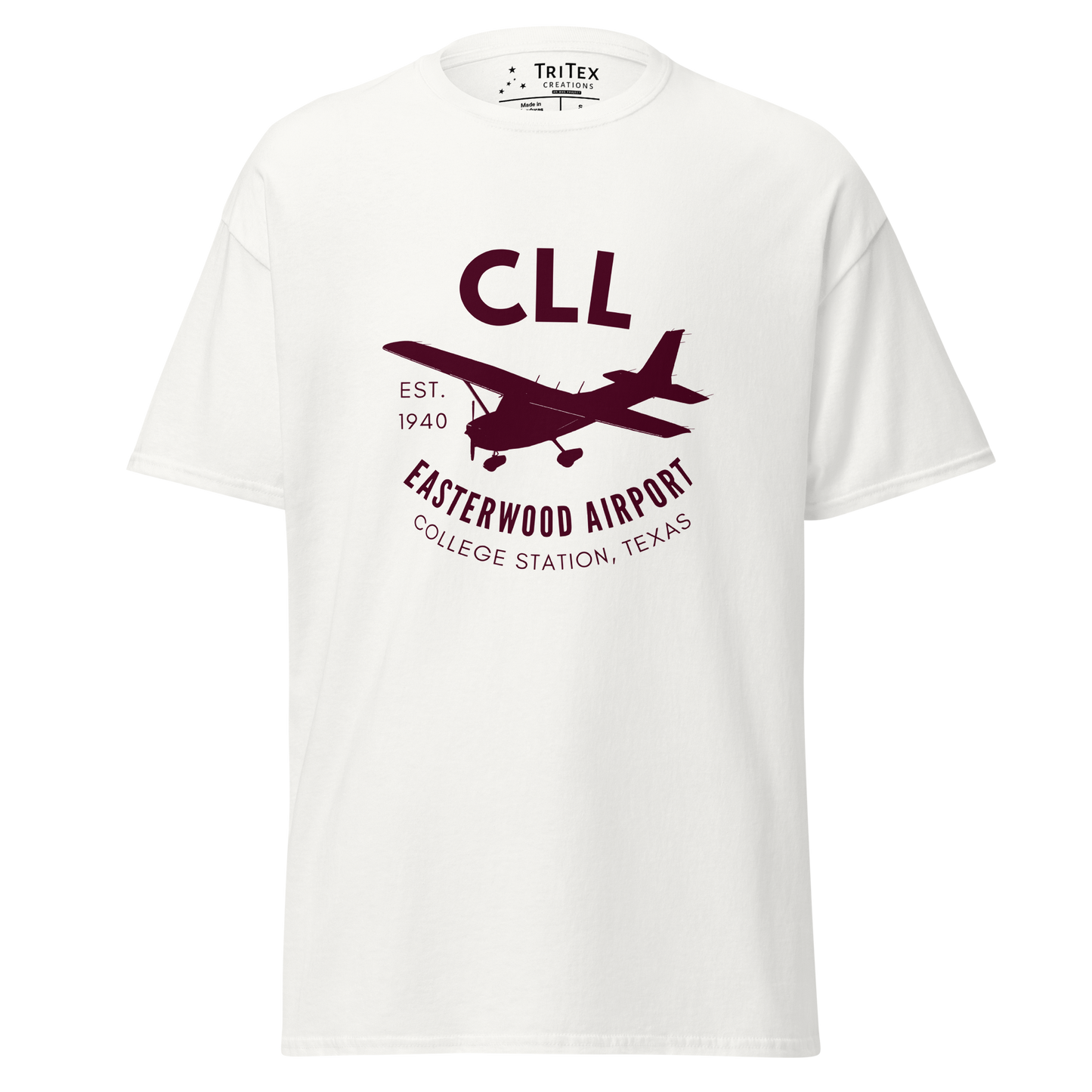 A white t-shirt featuring a silhouette of a Cessna airplane with the words "CLL Est. 1940 Easterwood Airport College Station, Texas".