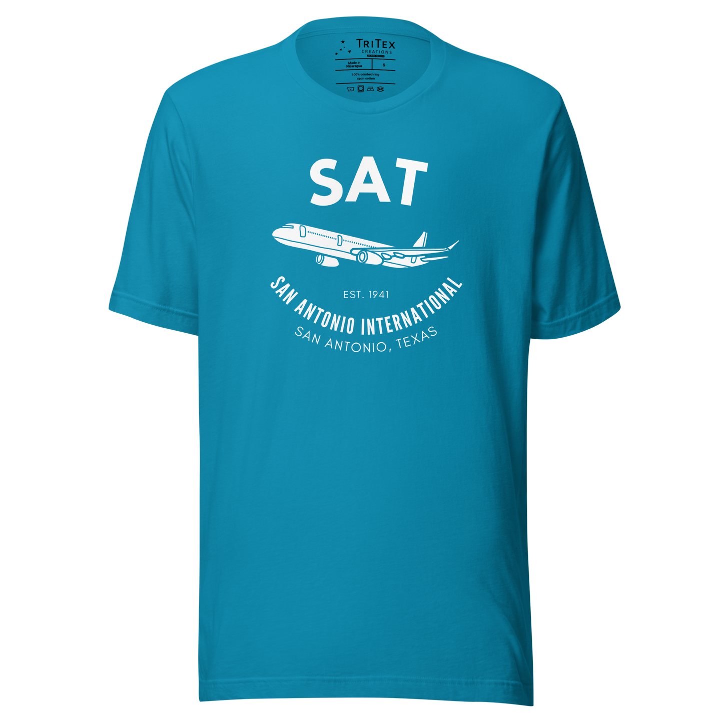 An aqua t-shirt featuring a silhouette of a passenger plane with the text "SAT. Est. 1941. San Antonio International. San Antonio, Texas".
