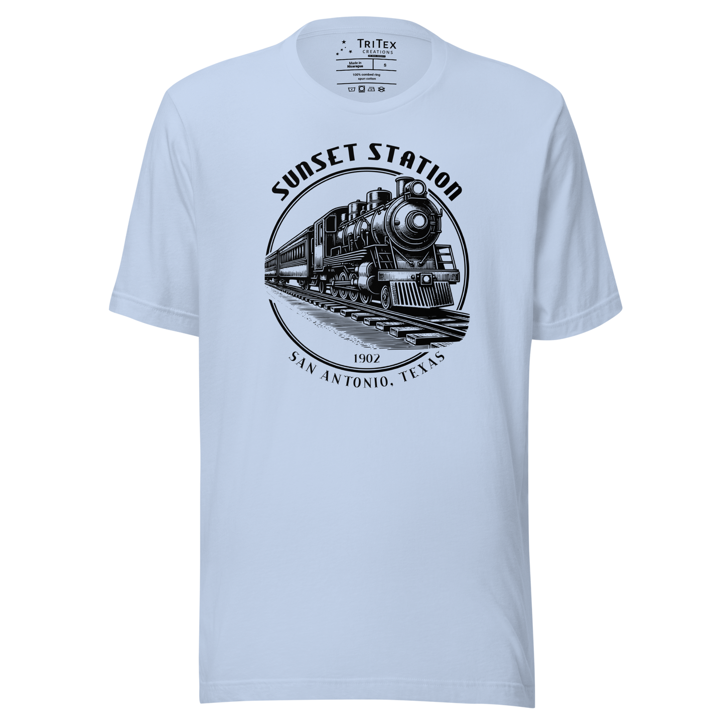 A baby blue t-shirt featuring a vintage locomotive with the words "Sunset Station. 1902. San Antonio, Texas".