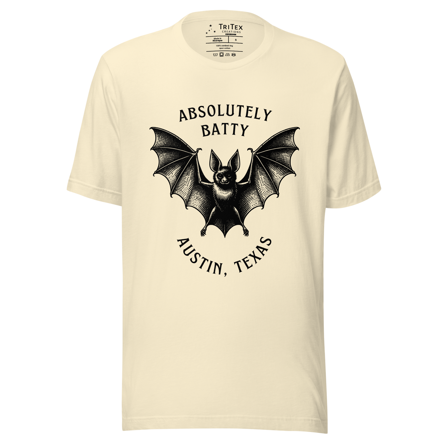A natural-colored t-shirt featuring an illustration of a bat with the words "Absolutely batty. Austin, Texas".