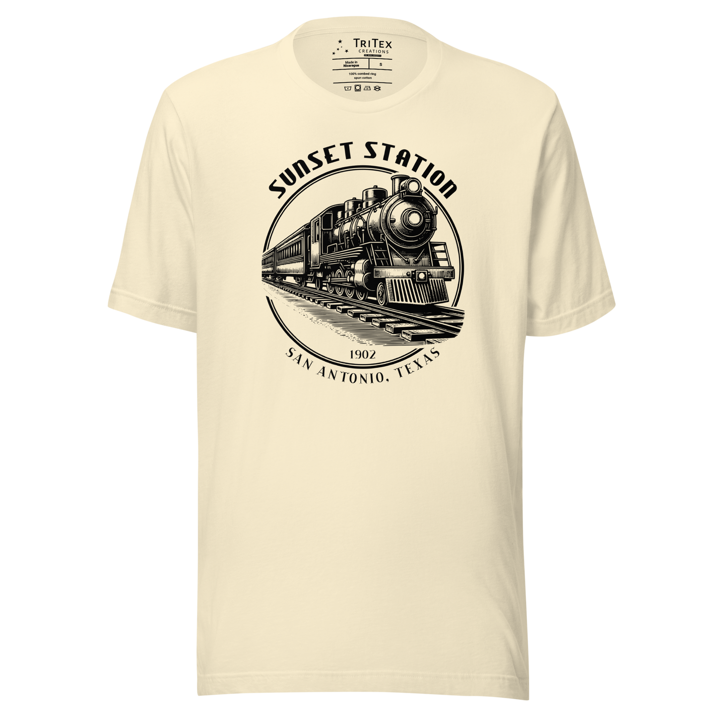 A natural-colored t-shirt featuring a vintage locomotive with the words "Sunset Station. 1902. San Antonio, Texas".