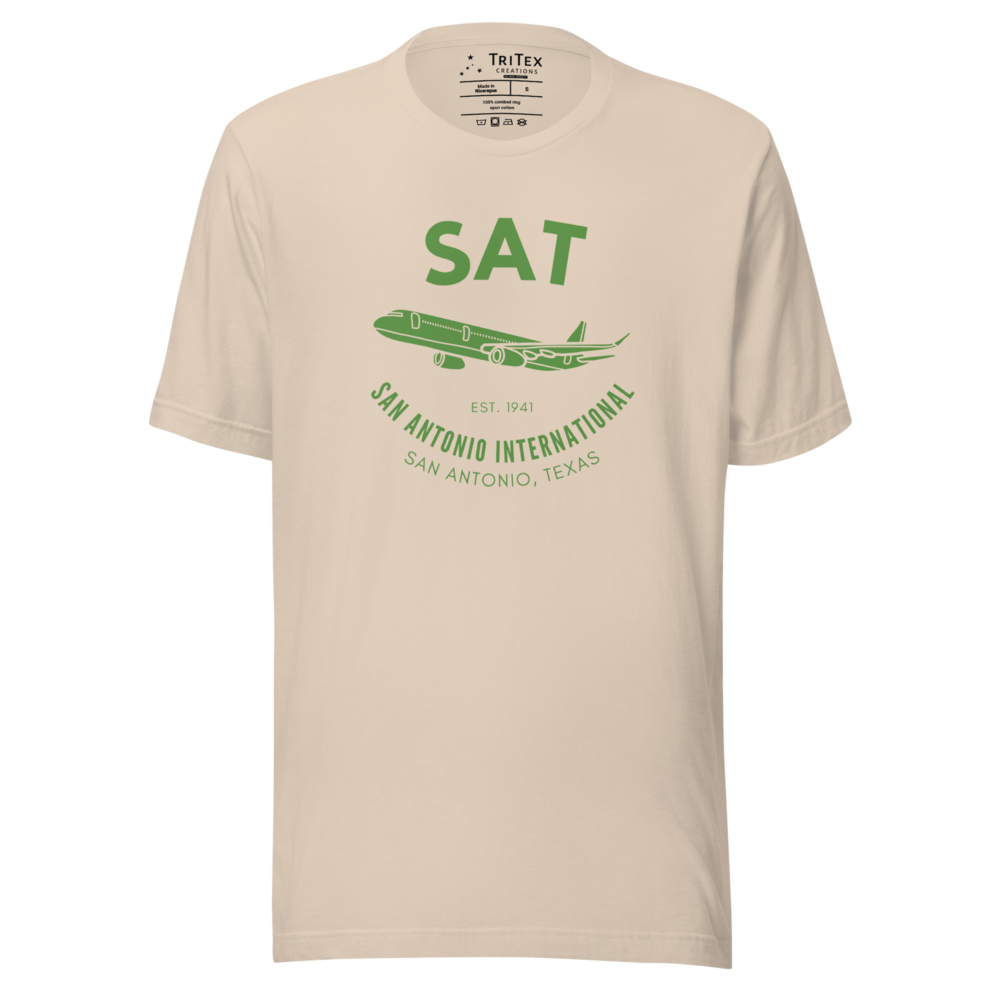 A soft green t-shirt featuring a silhouette of a passenger plane with the text "SAT. Est. 1941. San Antonio International. San Antonio, Texas".