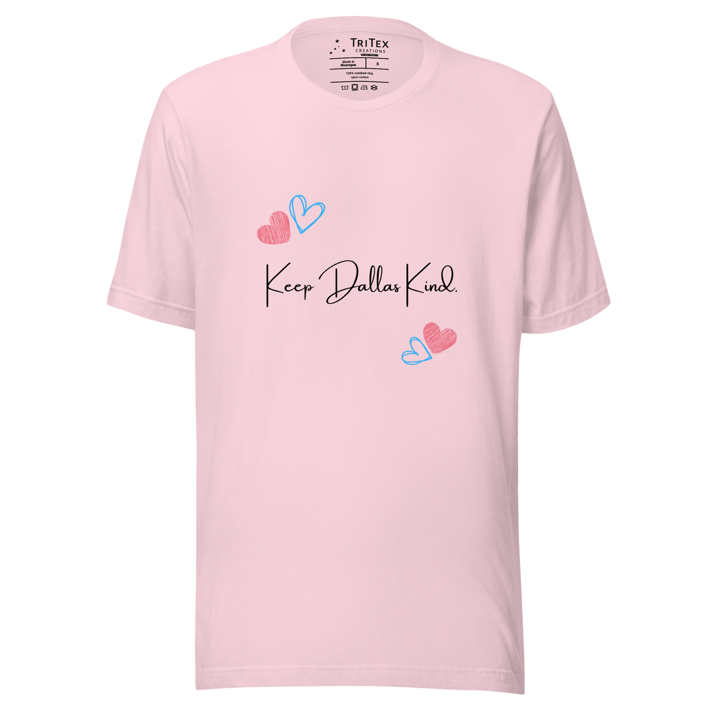 A soft pink t-shirt with hearts and the text "Keep Dallas Kind".