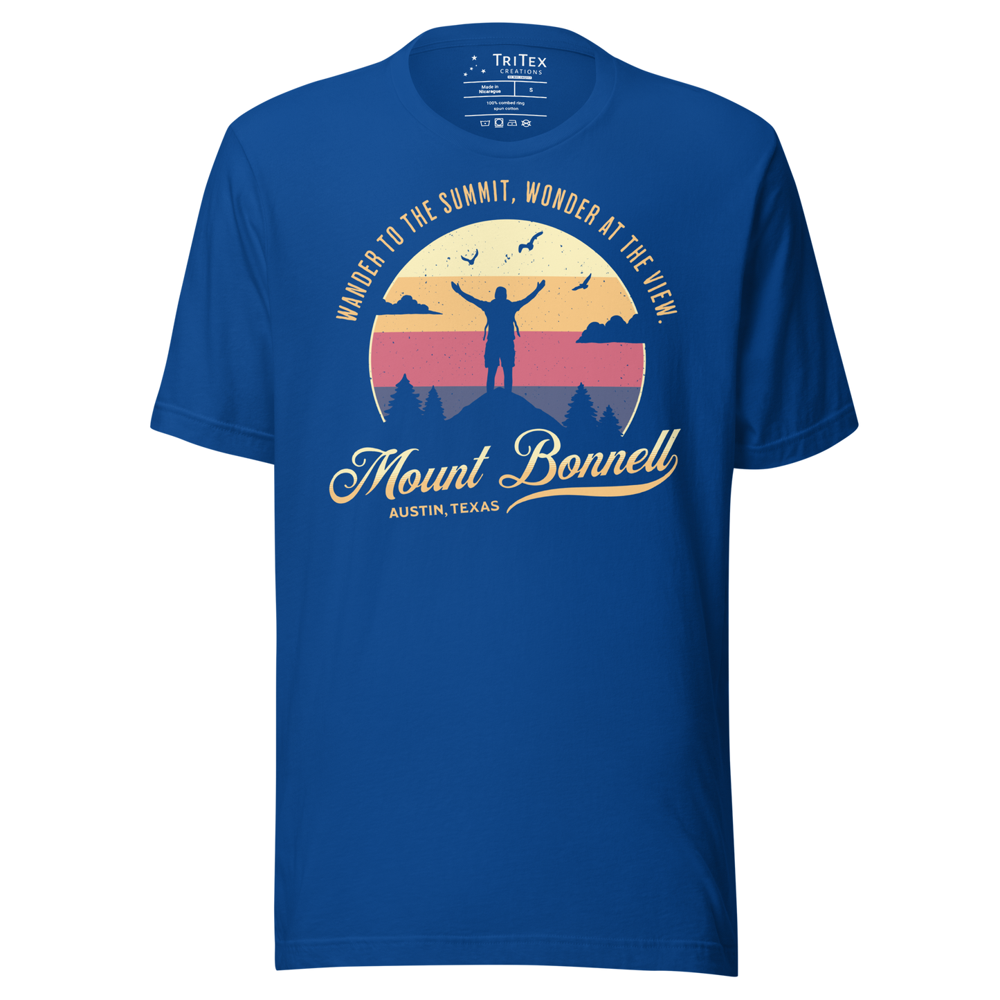 A true royal blue t-shirt featuring the silhouette of a person standing on a mountain with the words "Wander to the summit, wonder at the view".