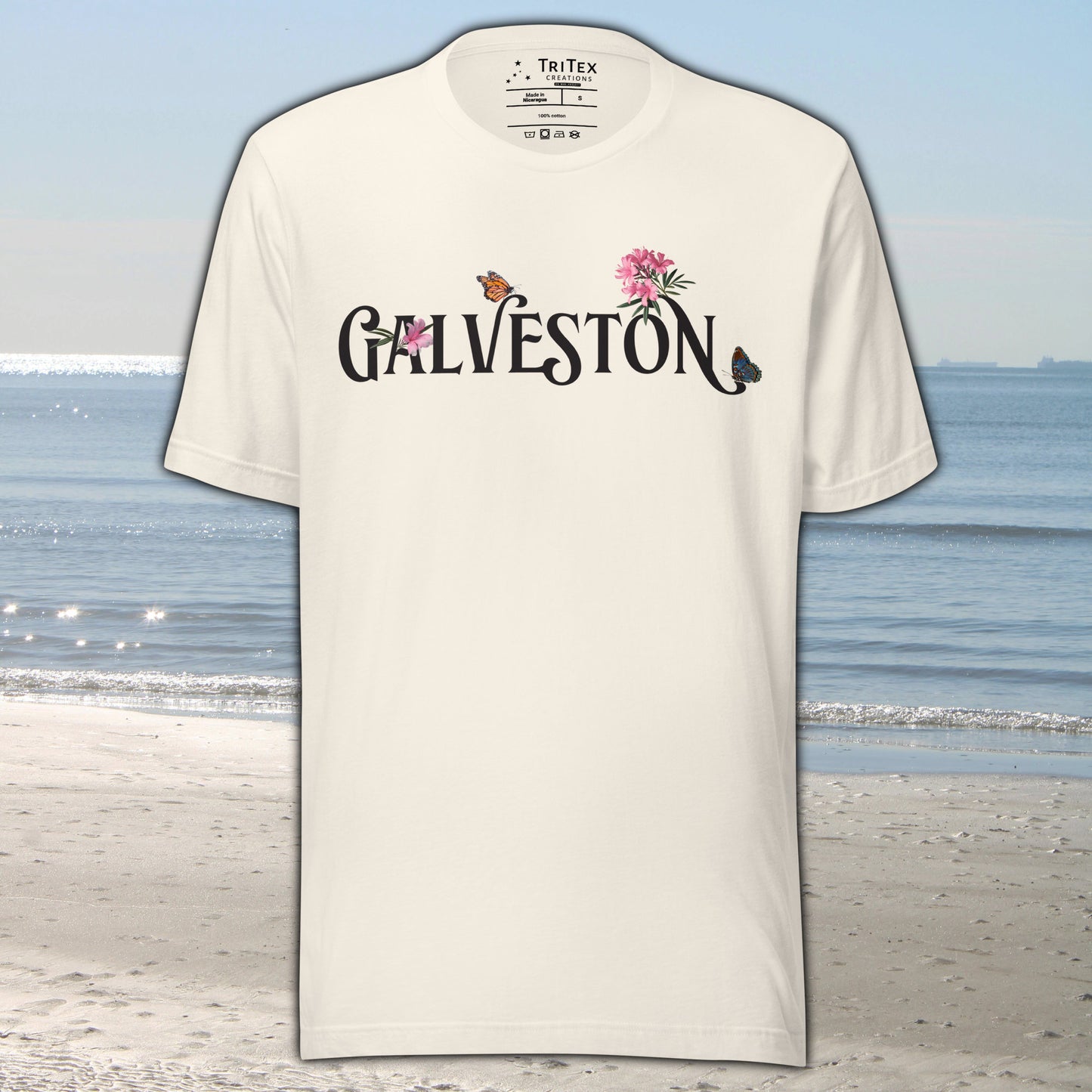 A vintage white t-shirt with the name of "Galveston" amongst oleanders and butterflies.