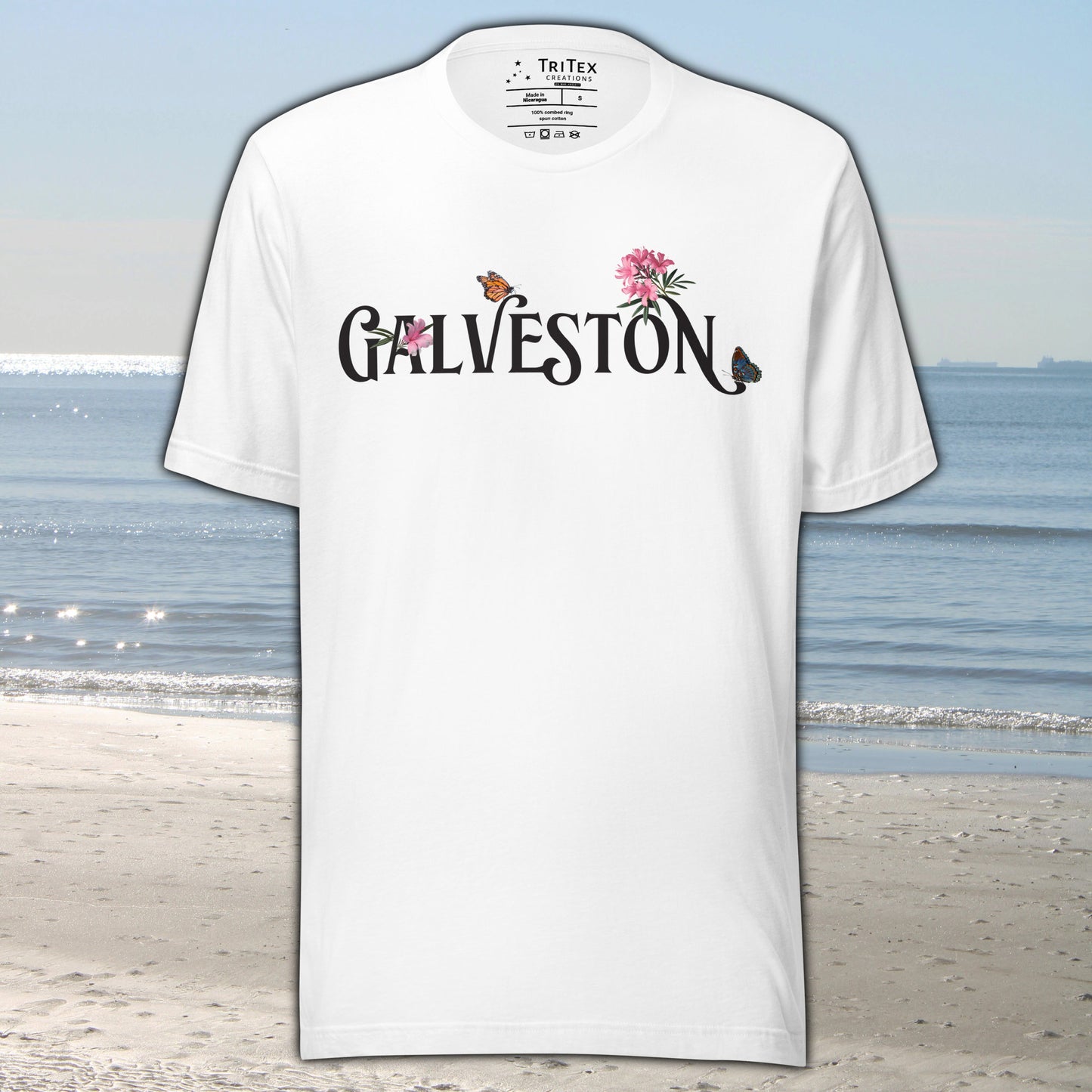 A white t-shirt with the name of "Galveston" amongst oleanders and butterflies.