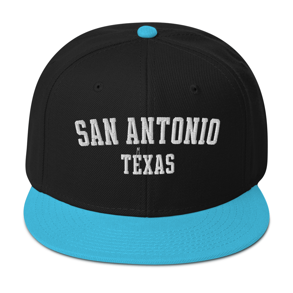 A black and aqua blue snapback cap with the words "San Antonio, Texas".