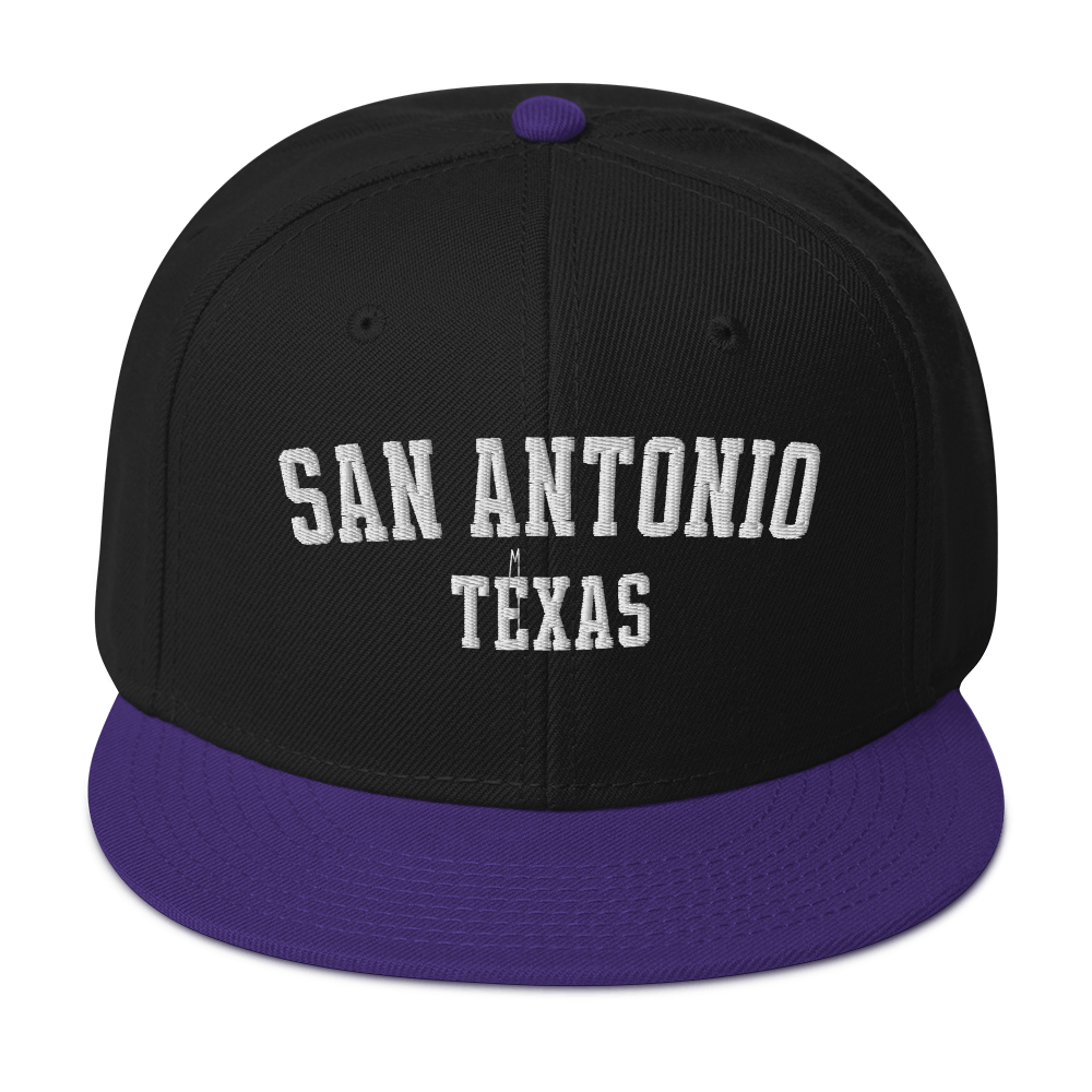 A black and purple snapback cap with the words "San Antonio, Texas".