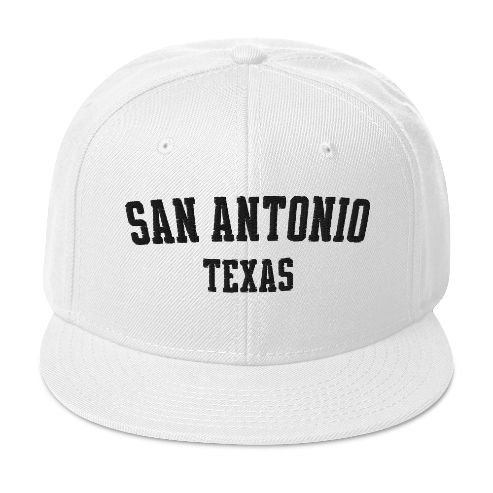 A white snapback cap with the words "San Antonio, Texas".