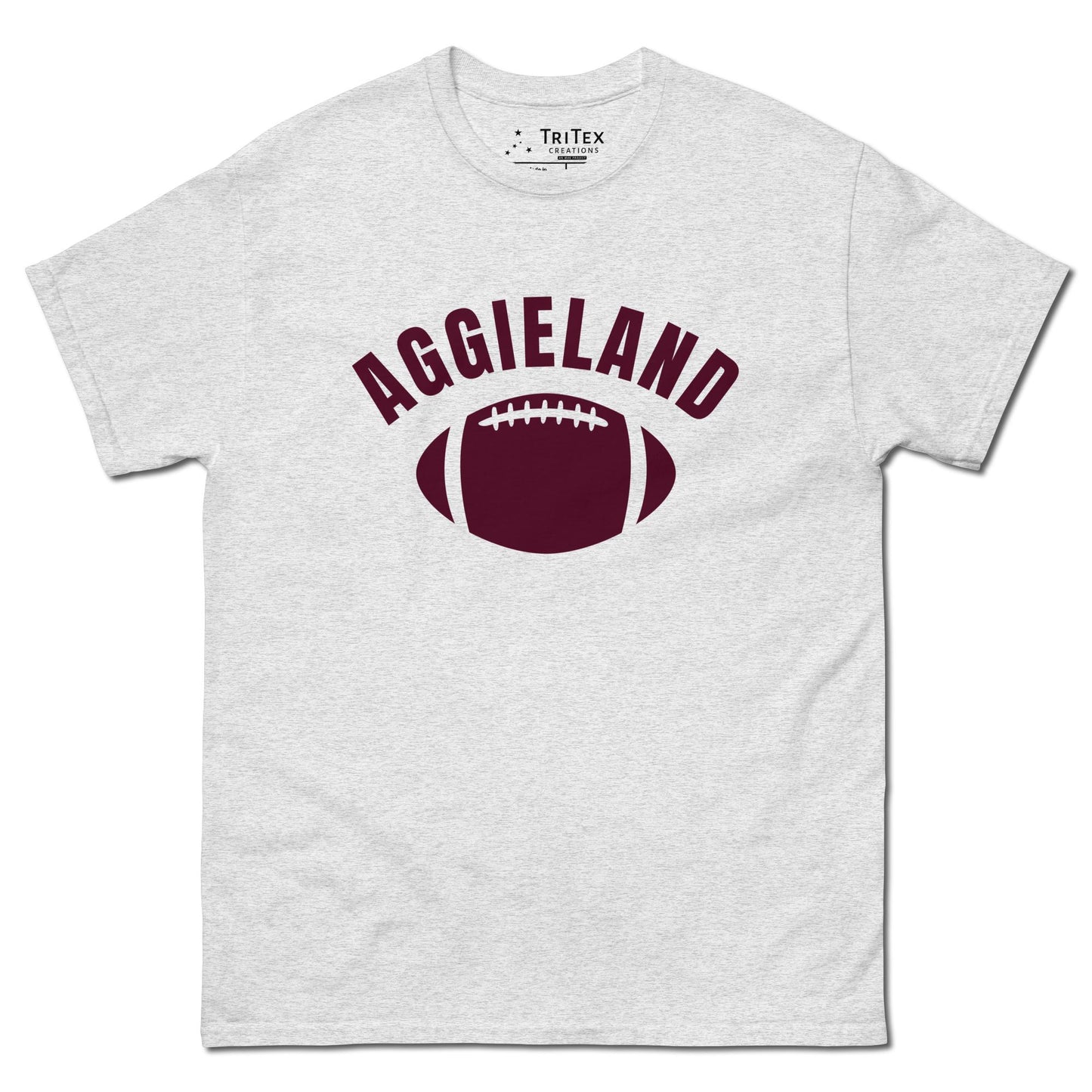 A ash t-shirt featuring a football with the word "Aggieland".