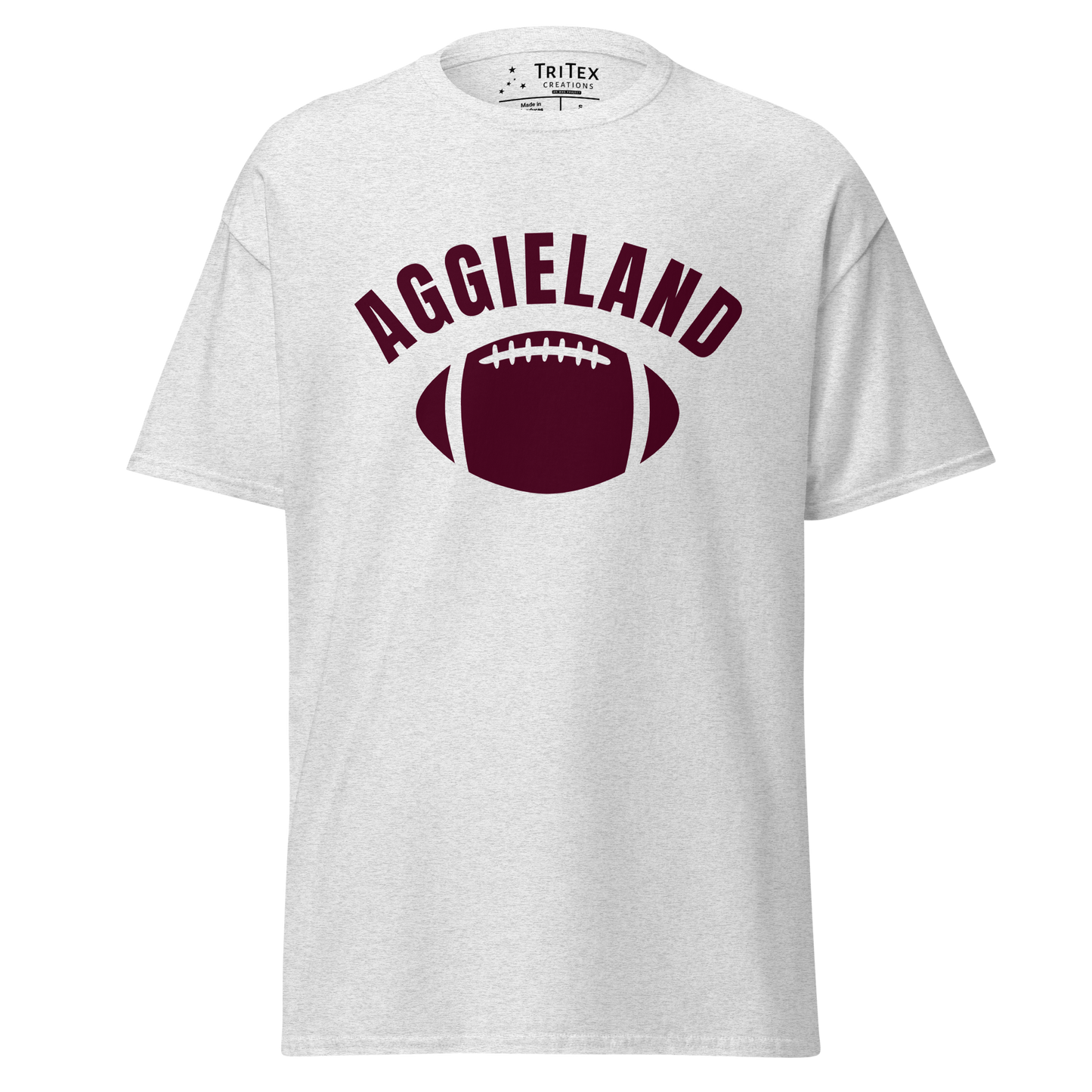 An ash-colored t-shirt featuring a football with the word "Aggieland".