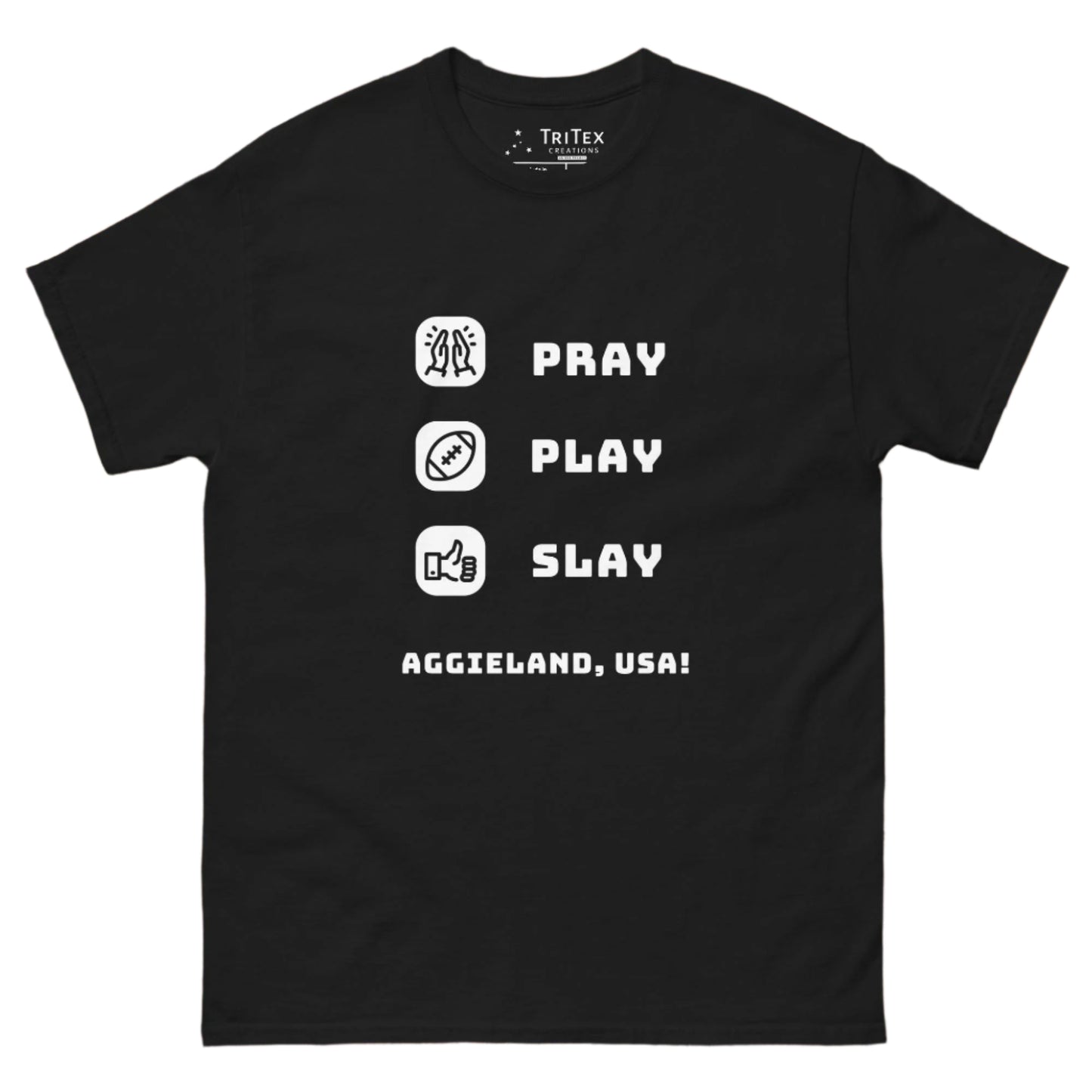 A black t-shirt featuring the words "Pray, Play, Slay, Aggieland, USA!" with matching icons.