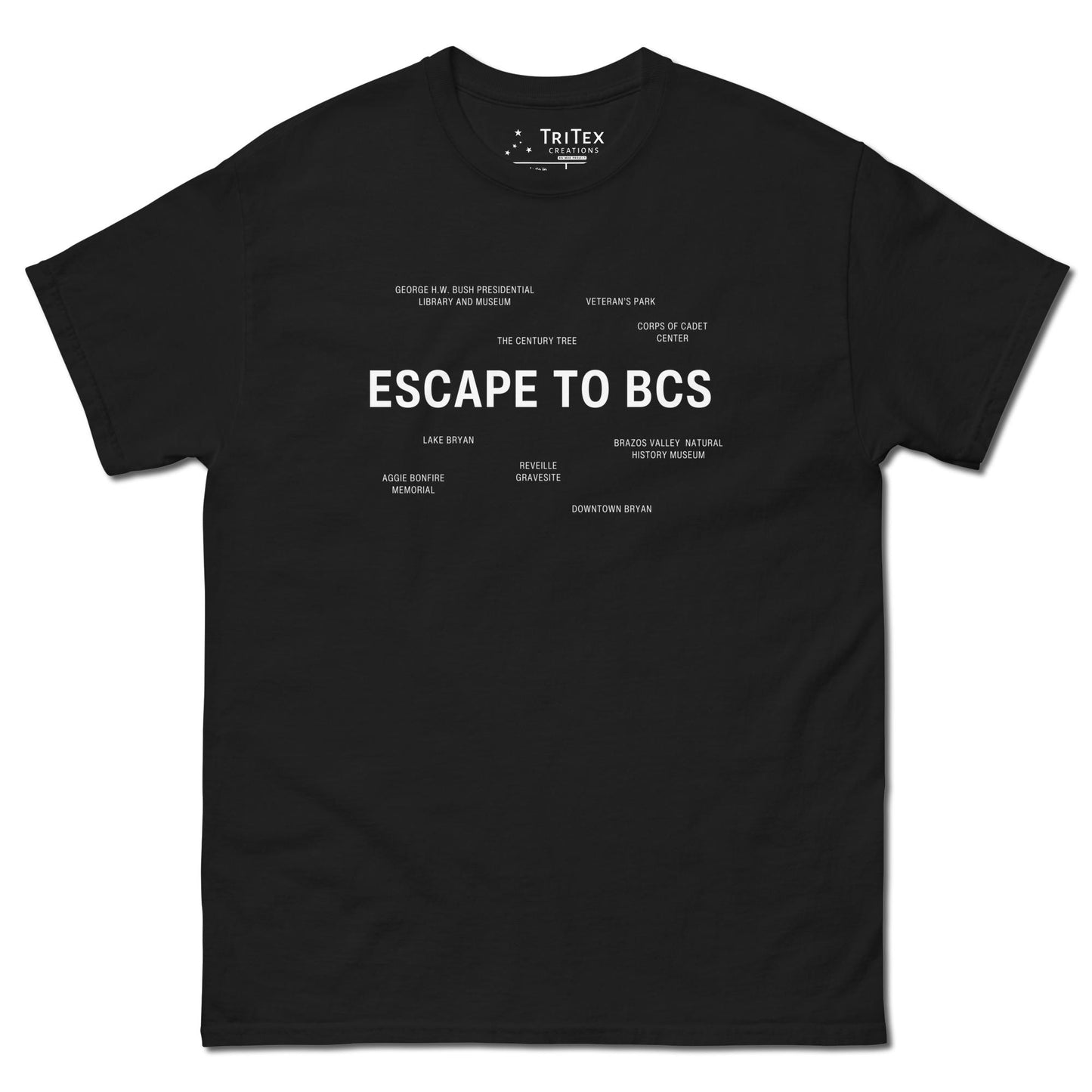 A black t-shirt which reads "Escape To BCS" in big, bold text with smaller text elements naming Bryan and College Station's landmarks.