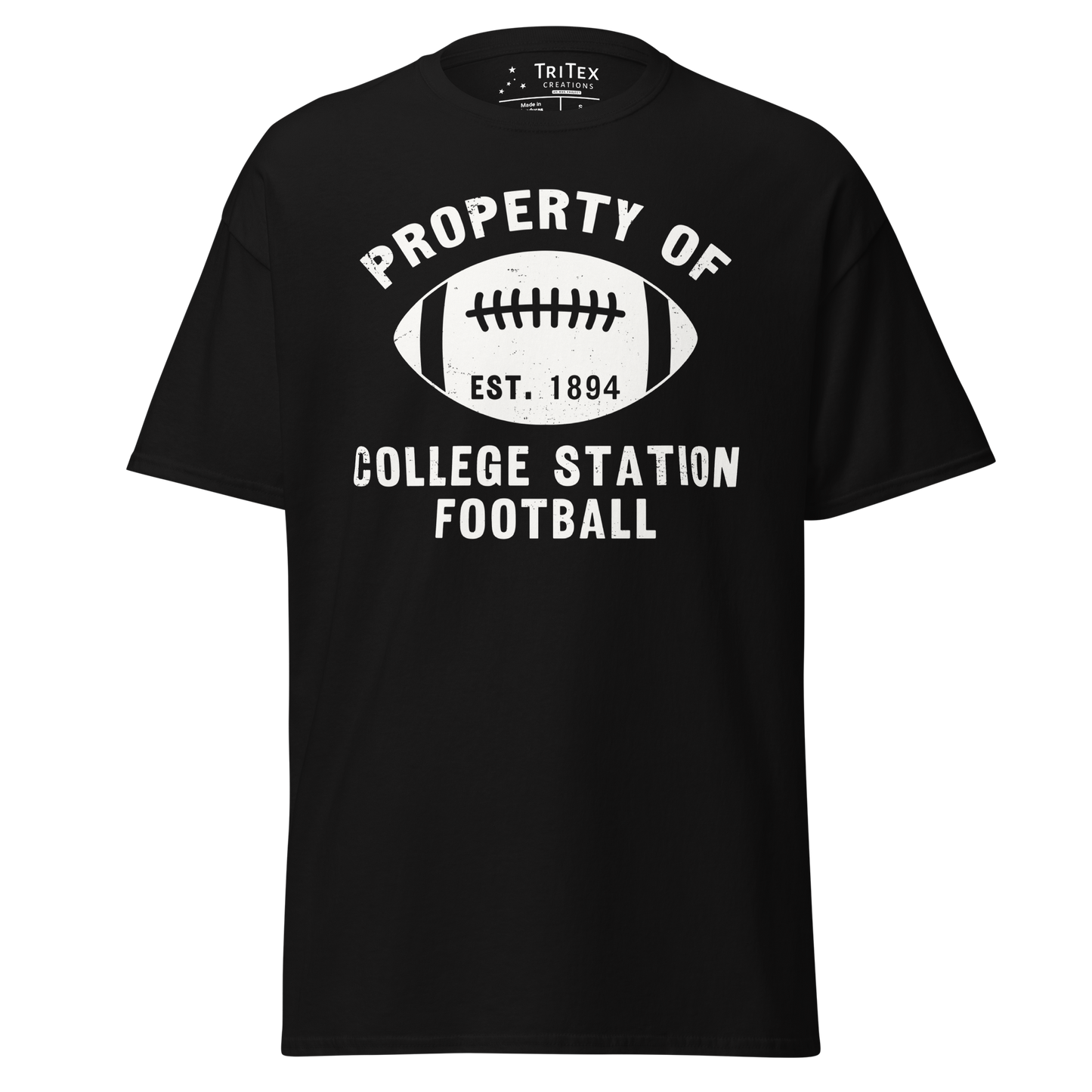 A black t-shirt featuring a silhouette of a football with the words "Property of College Station football. Est. 1894".