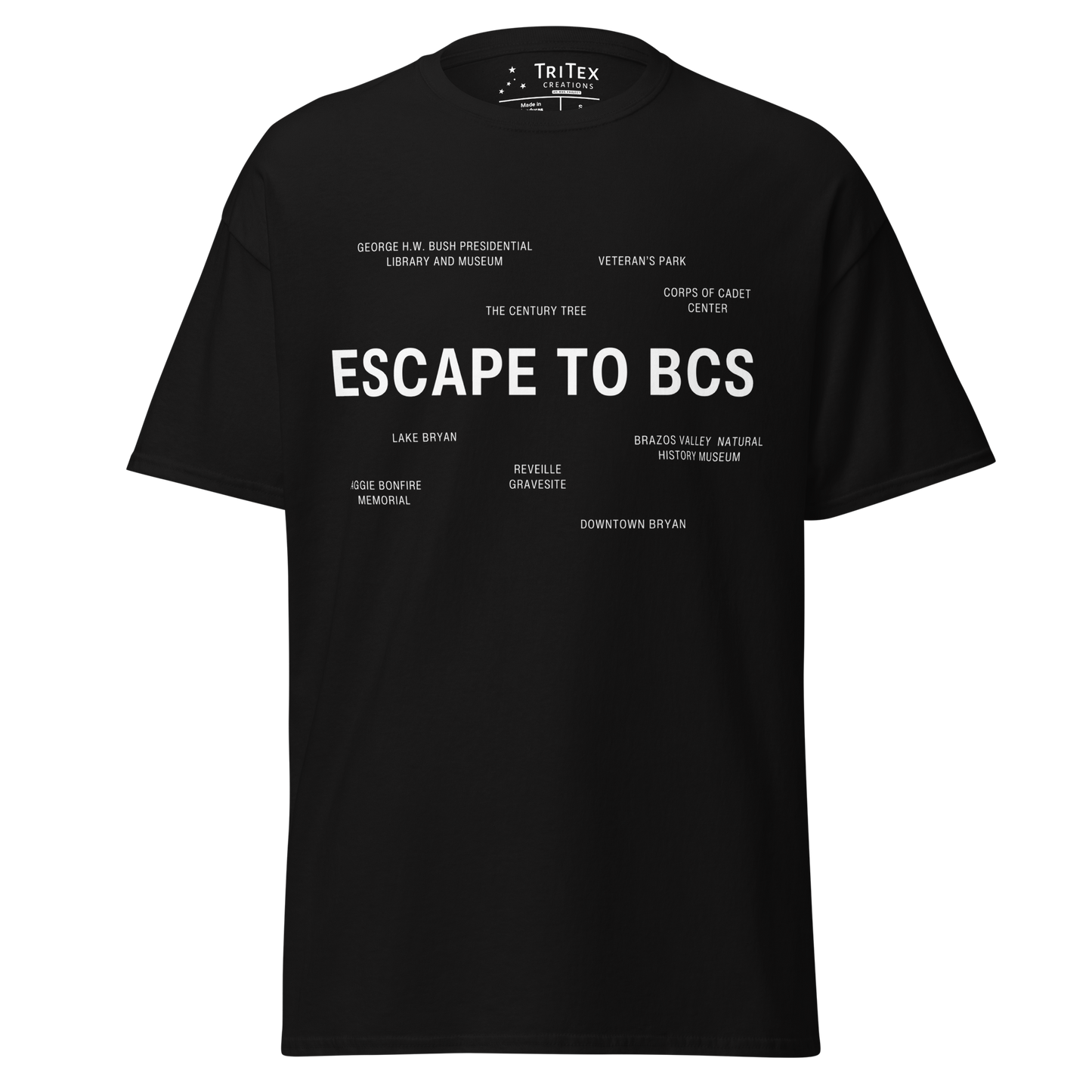 A black t-shirt which reads "Escape To BCS" in big, bold text with smaller text elements naming Bryan and College Station's landmarks.