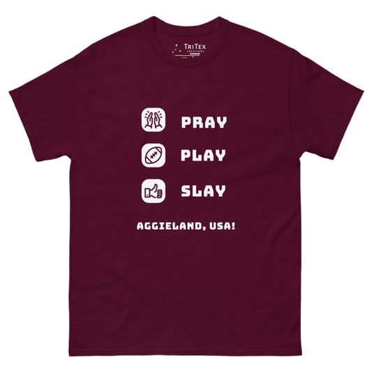 A maroon t-shirt featuring the words "Pray, Play, Slay, Aggieland, USA!" with matching icons.