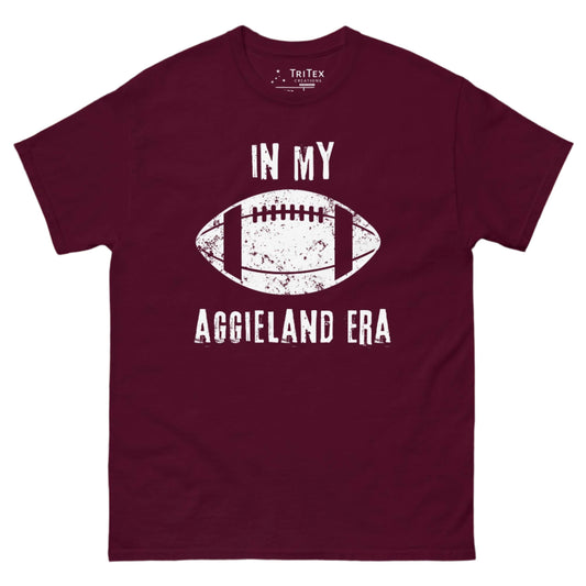 A maroon t-shirt featuring a vintage graphic of a football and the text "In My Aggieland Era".