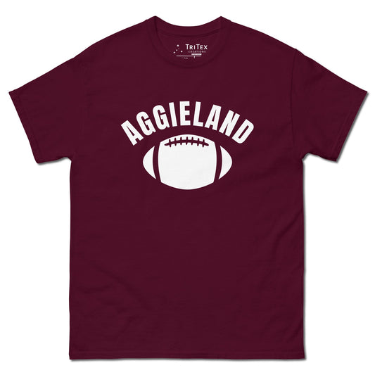 A maroon t-shirt featuring a football with the word "Aggieland".