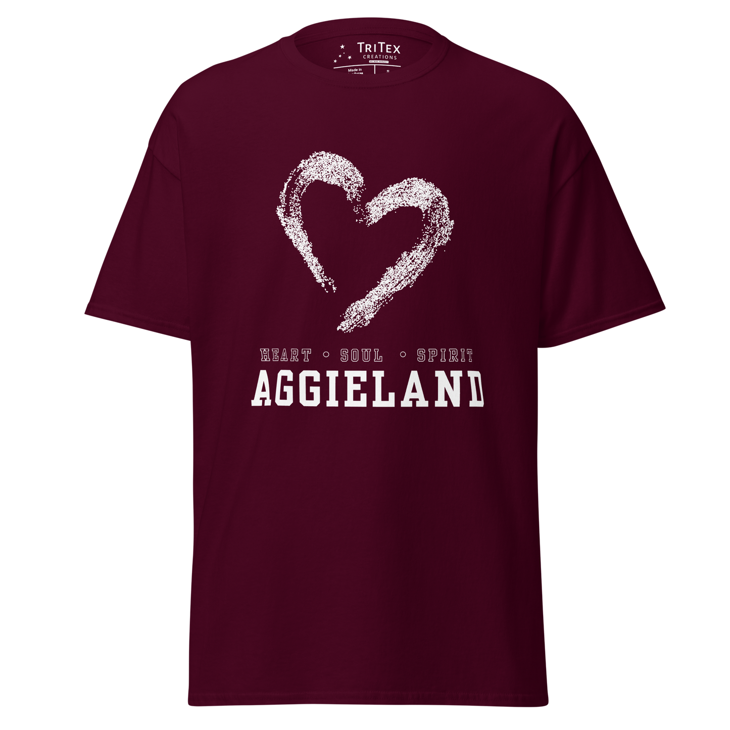 A maroon t-shirt featuring the outline of a heart with the words "Heart, soul, spirit Aggieland".