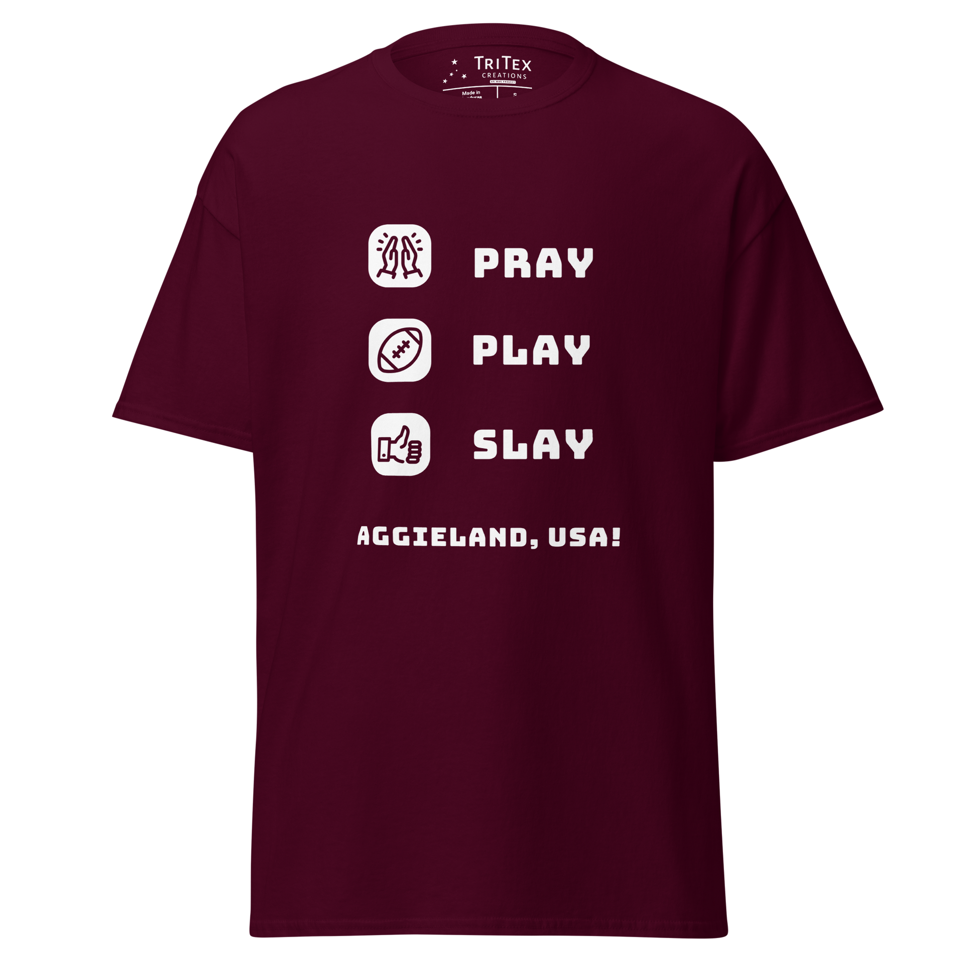 A maroon t-shirt featuring the words "Pray, Play, Slay, Aggieland, USA!" with matching icons.