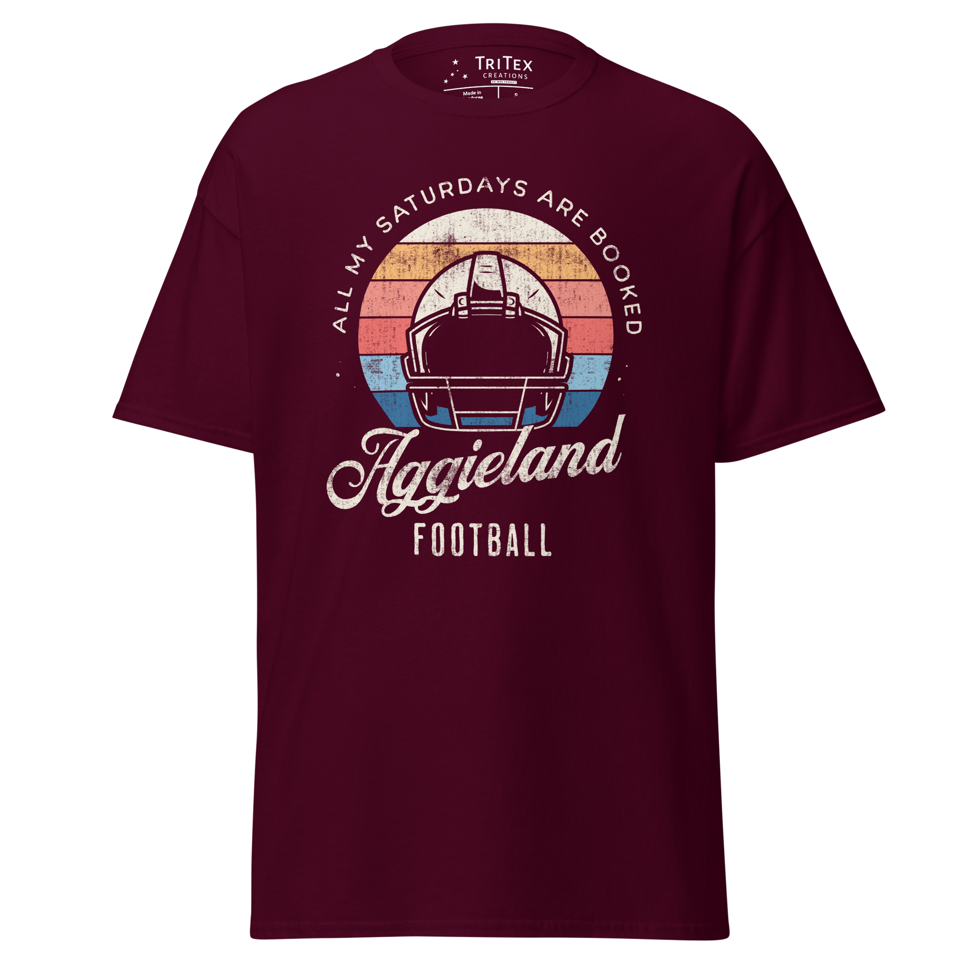 A maroon t-shirt featuring a football helmet and the words "All my Saturdays are booked Aggieland Football".