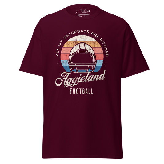 A maroon t-shirt featuring a football helmet and the words "All my Saturdays are booked Aggieland Football".