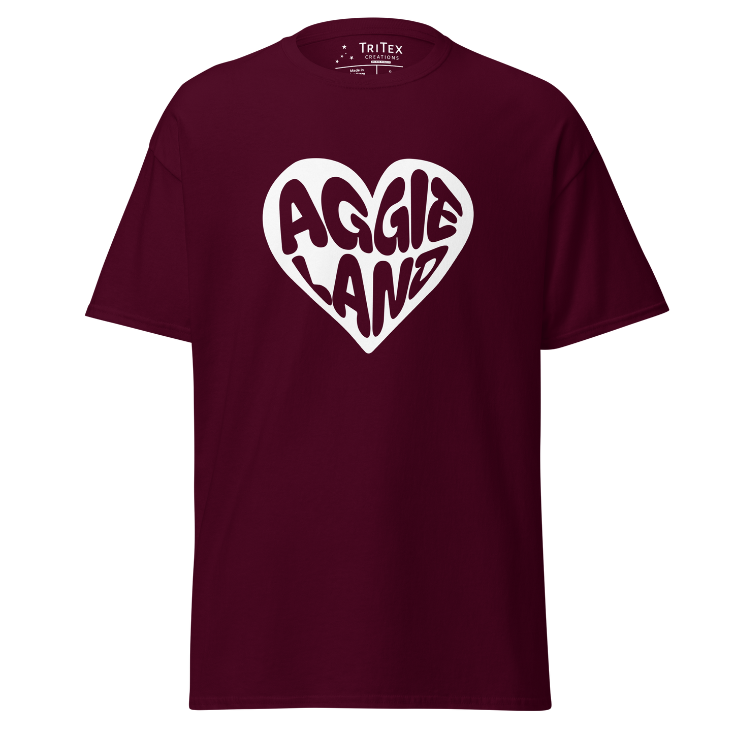 A maroon t-shirt featuring a white heart with "Aggieland" written in it.