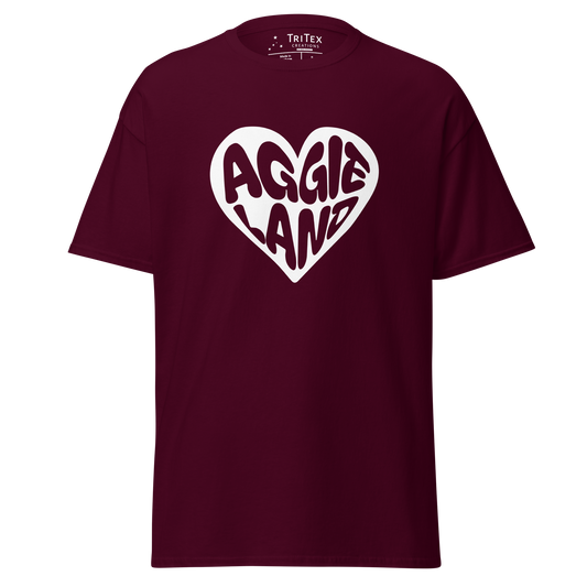 A maroon t-shirt featuring a white heart with "Aggieland" written in it.