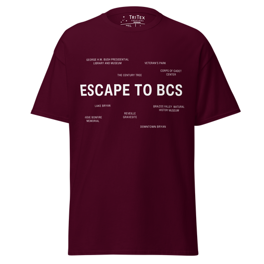 A maroon t-shirt which reads "Escape To BCS" in big, bold text with smaller text elements naming Bryan and College Station's landmarks.