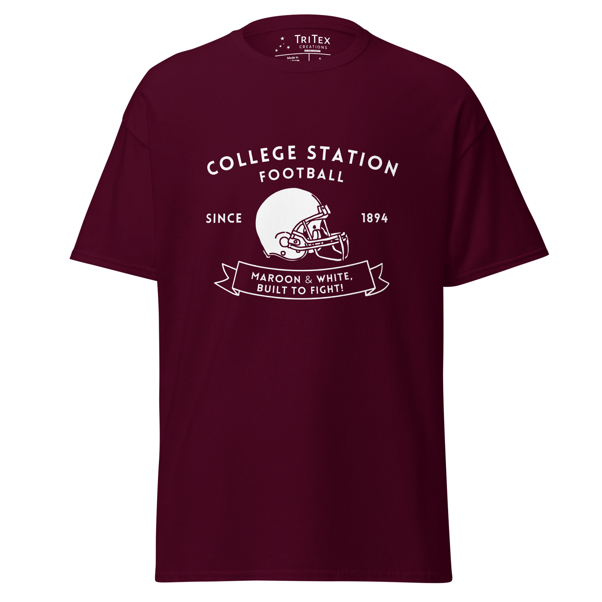 A maroon t-shirt with the text "College Station football since 1894 Maroon & White, Built to fight!" featuring an image of a football helmet.