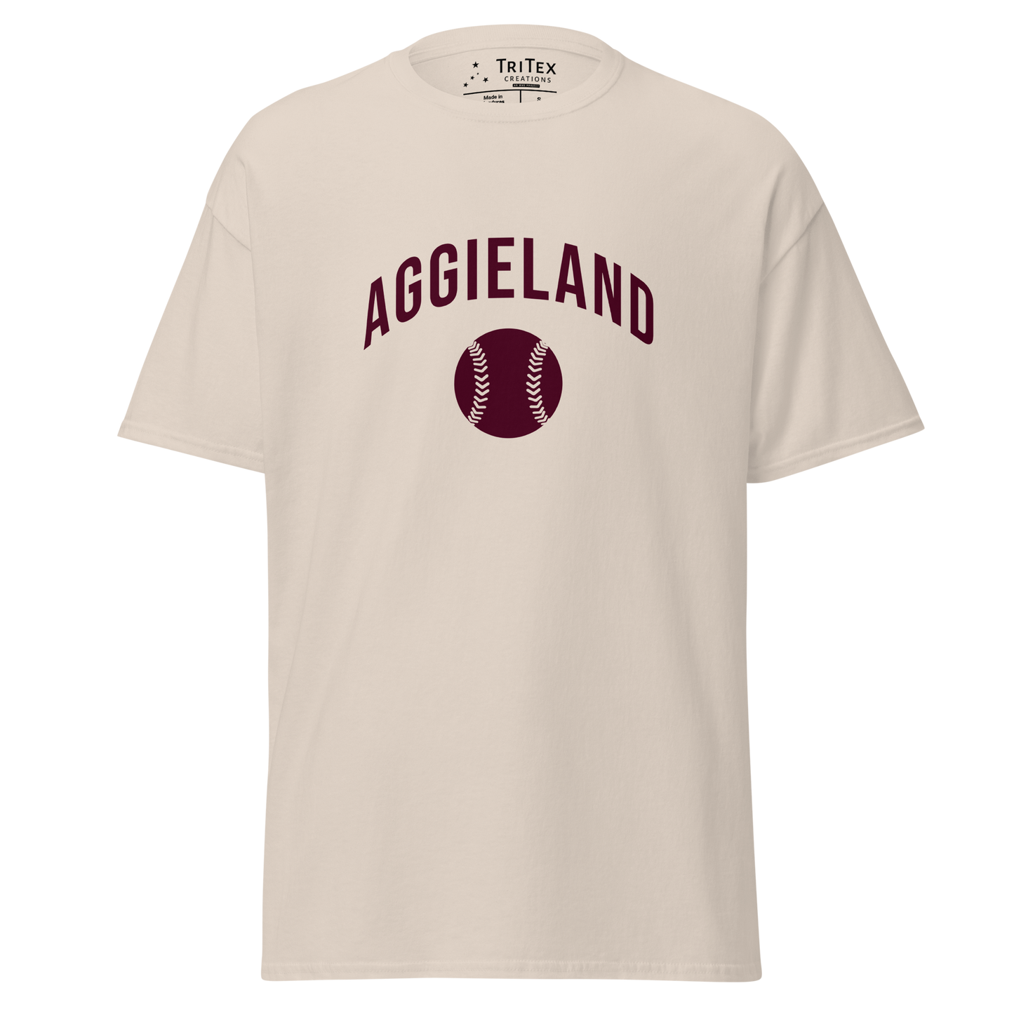 A natural-colored t-shirt featuring an image of a baseball with the words "Aggieland".