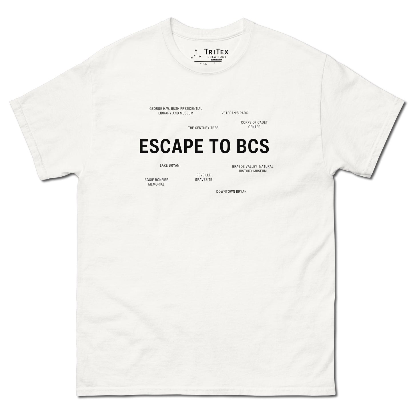 A white t-shirt which reads "Escape To BCS" in big, bold text with smaller text elements naming Bryan and College Station's landmarks.