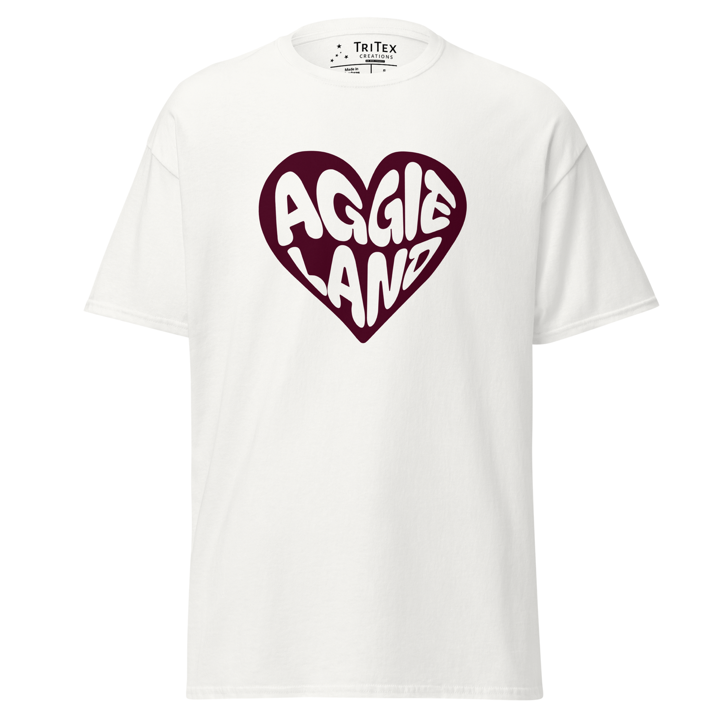 A white t-shirt featuring a maroon heart with "Aggieland" written in it.