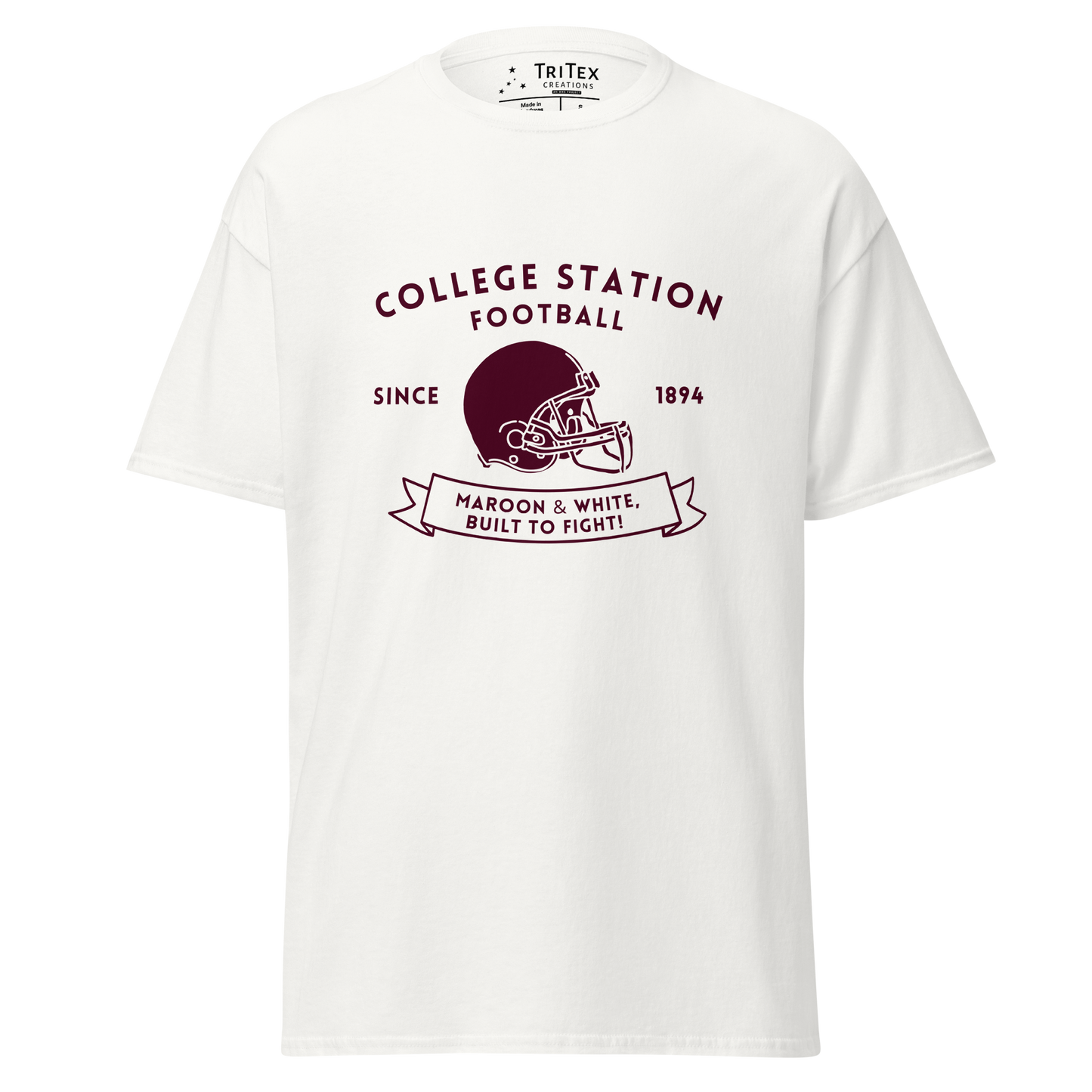 A white t-shirt with the text "College Station football since 1894 Maroon & White, Built to fight!" featuring an image of a football helmet.