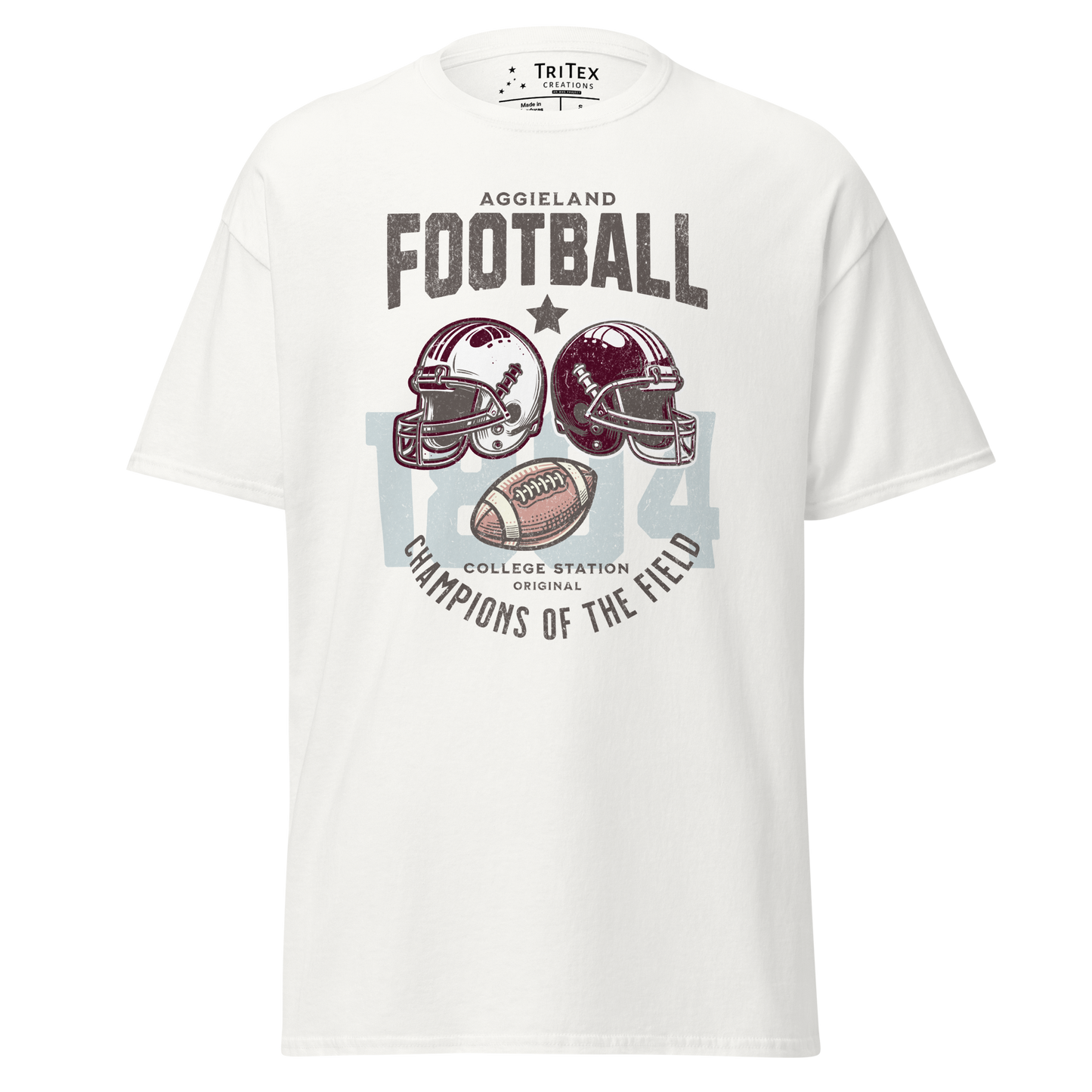 A white t-shirt featuring football helmets and a football with the text "Aggieland Football College Station original Champions of the field"