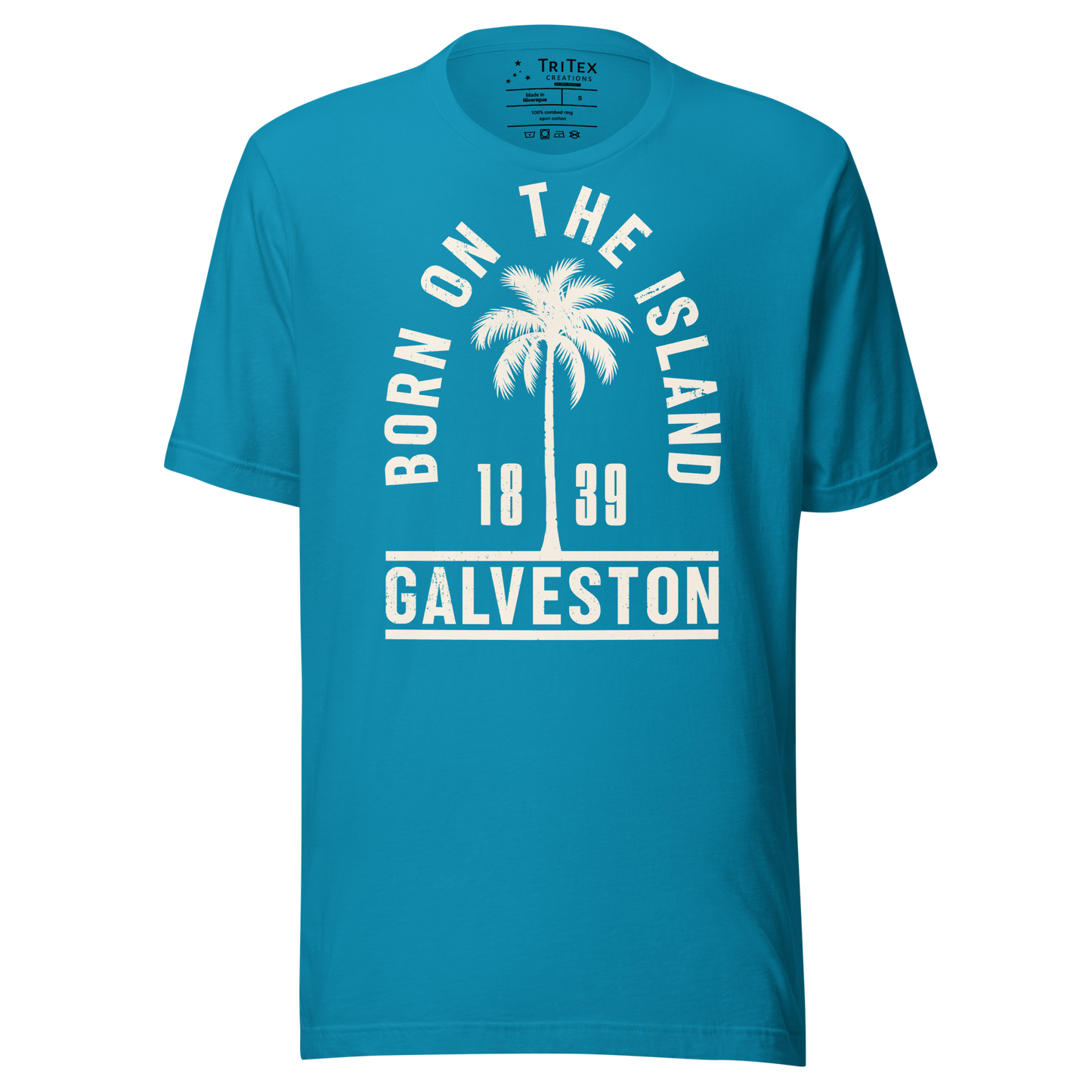 An aqua t-shirt featuring a palm tree with the words "Born on the island. Galveston 1839" with a silhouette of a palm tree.
