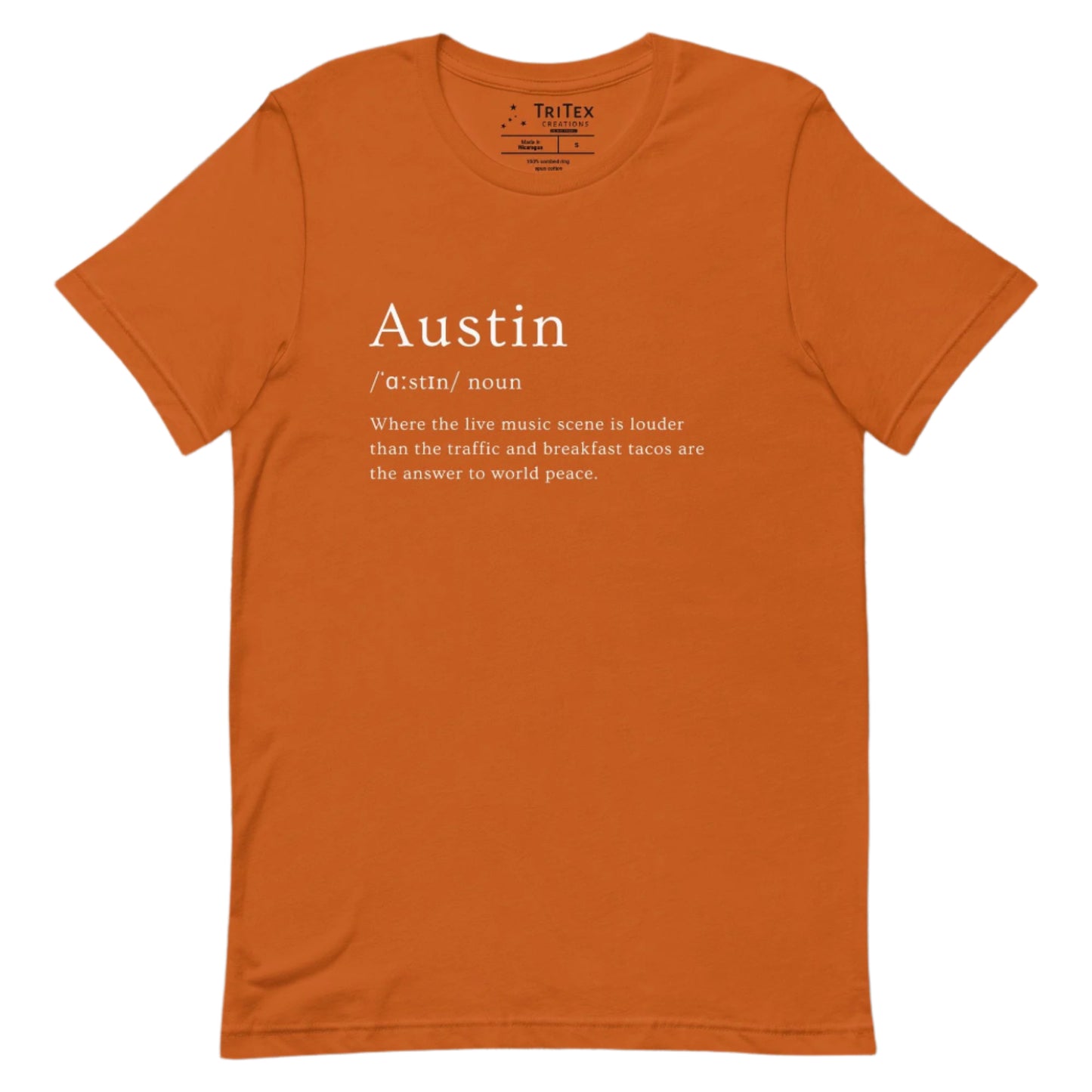 An autumn-colored t-shirt with the words "Austin where the live music scene is louder than the traffic and breakfast tacos are the answer to world peace".