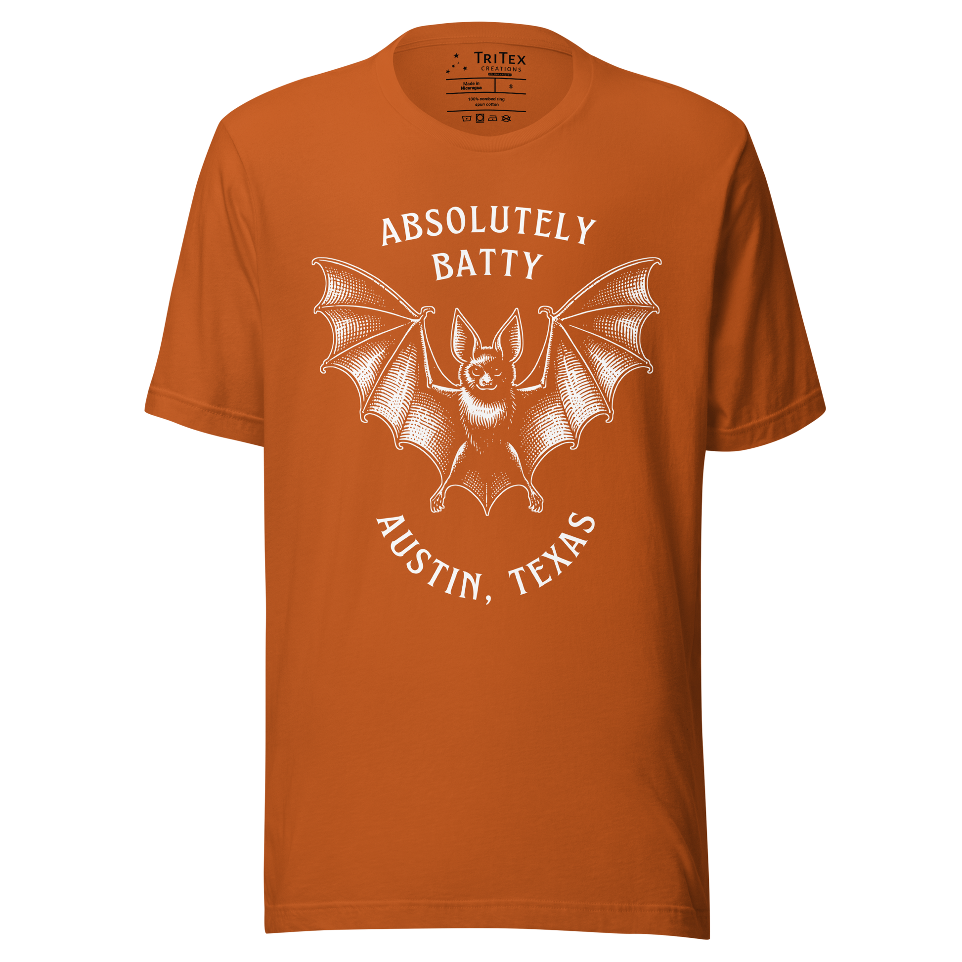 An autumn-colored t-shirt featuring an illustration of a bat with the words "Absolutely batty. Austin, Texas".