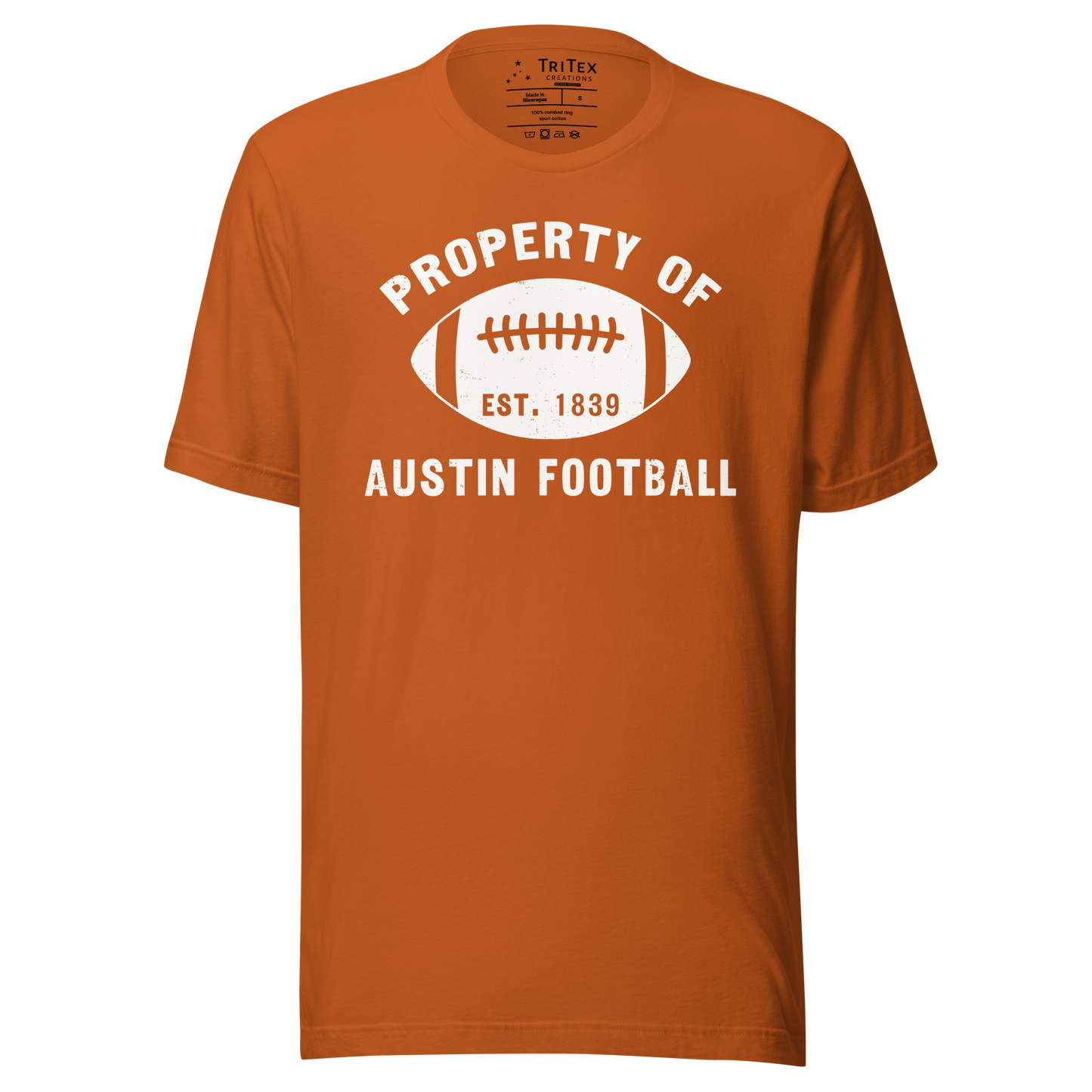 An autumn colored t-shirt featuring a silhouette of a football with the words "Property of Austin football. Est. 1839".