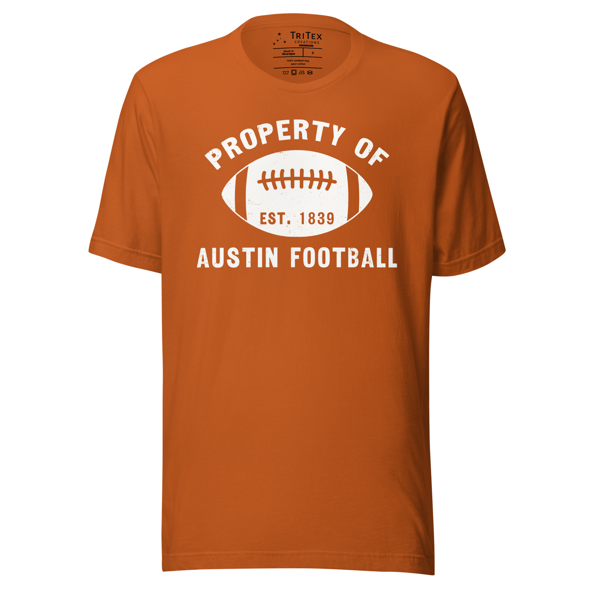 An autumn colored t-shirt featuring a silhouette of a football with the words "Property of Austin football. Est. 1839".