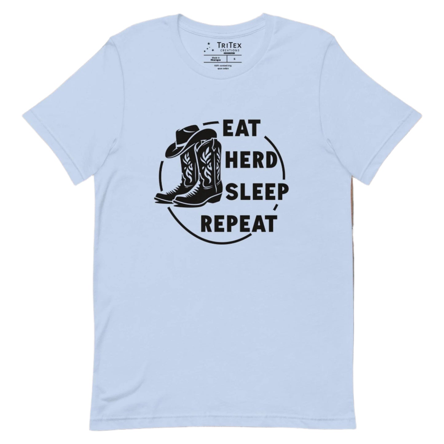 A baby blue t-shirt featuring boots and a cowboy hat with the words "Eat, herd, sleep, repeat".