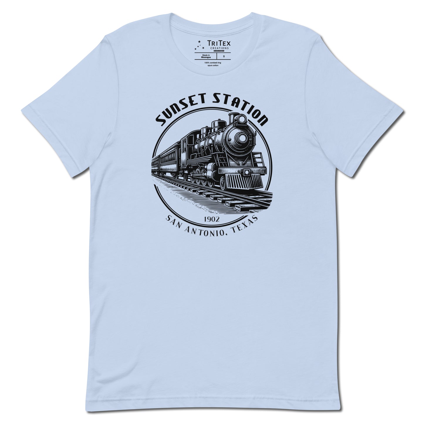 A baby blue t-shirt featuring a vintage locomotive  with the words "Sunset Station. 1902. San Antonio, Texas".