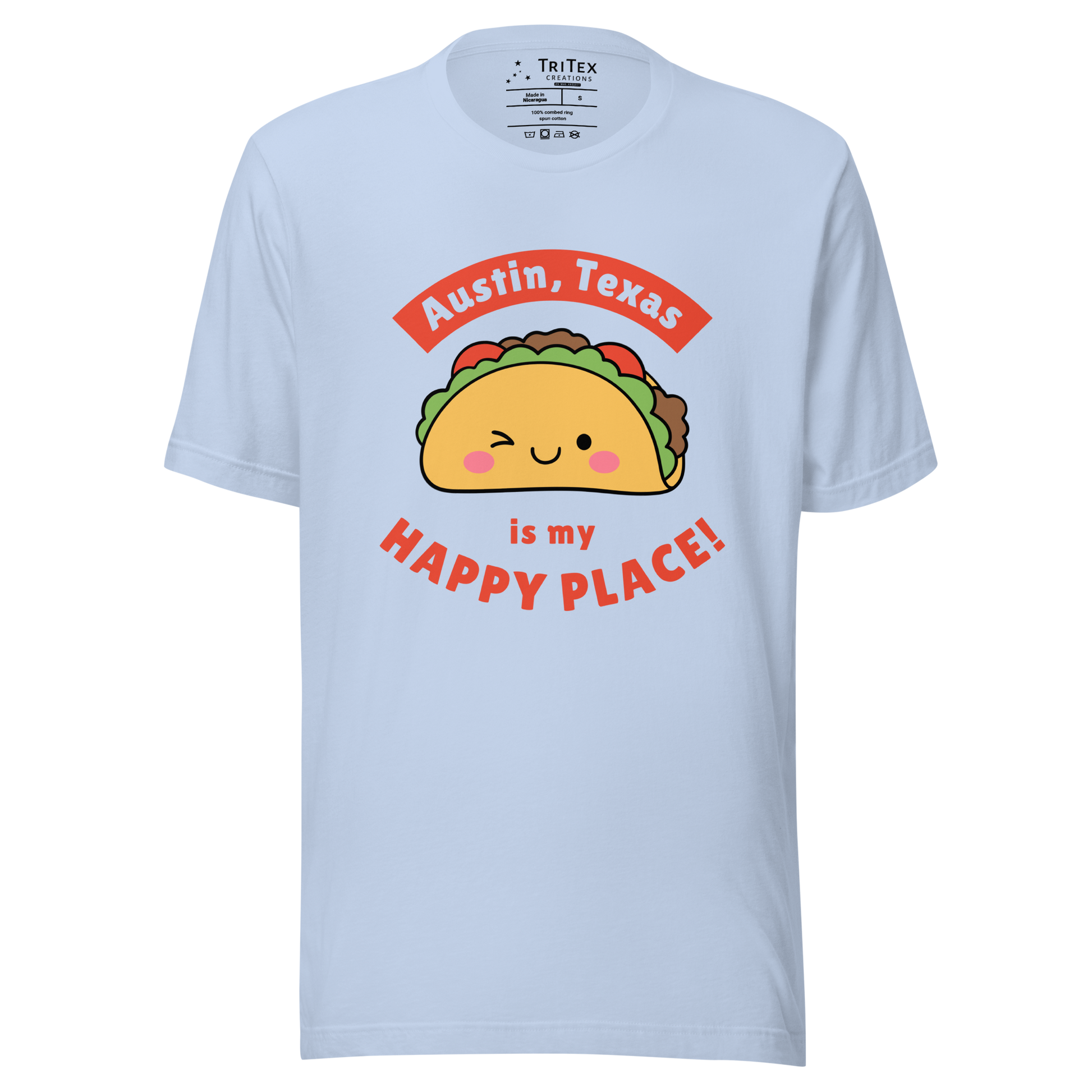 A baby blue t-shirt featuring a smiling, winking cartoon taco with the words "Austin, Texas is my happy place!".