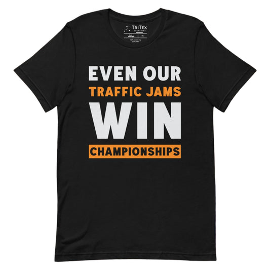 A black t-shirt with text reading "Even Our Traffic Jams Win Championships".