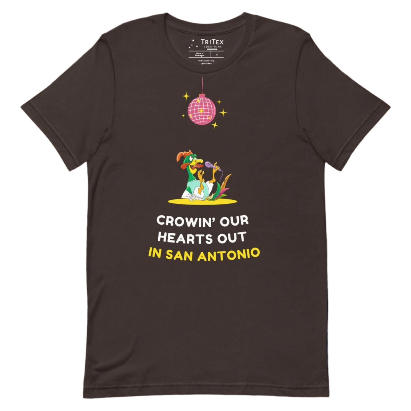 A brown t-shirt featuring a rooster singing it's lungs out under a disco ball above the words "Crowin' our hearts out in San Antonio".