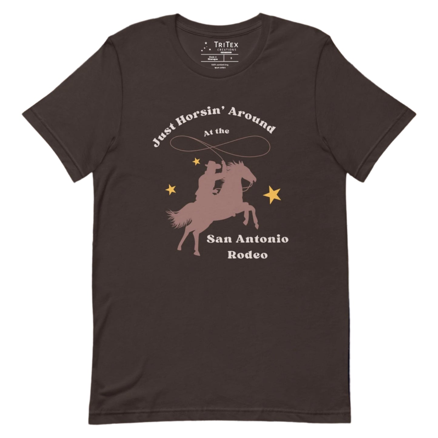 A brown t-shirt featuring a cowboy with a lasso on a horse and text that reads "Just horsin' around at the San Antonio Rodeo".